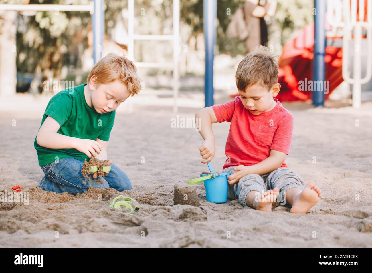 Two Caucasian children sitting in sandbox playing with beach toys. Little  boys friends having fun together on playground. Summer outdoor activity for  Stock Photo - Alamy