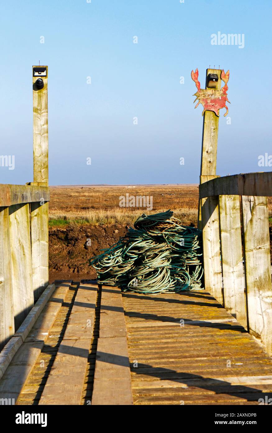 A fishing boat mooring point with coiled ropes in a North Norfolk creek at Morston, Norfolk, England, United Kingdom, Europe. Stock Photo