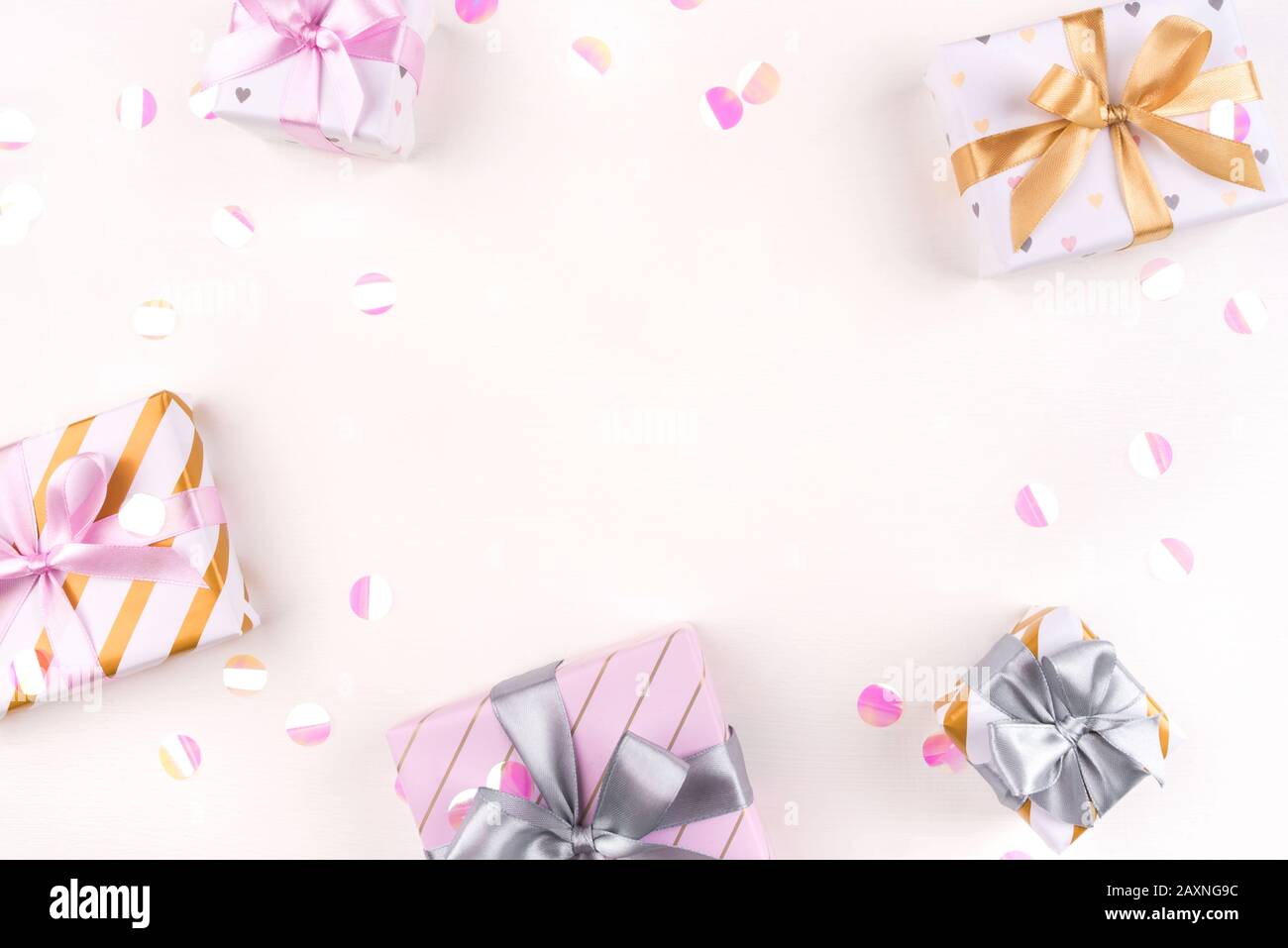 Several gift boxes with bows and confetti on a white background. Stock Photo