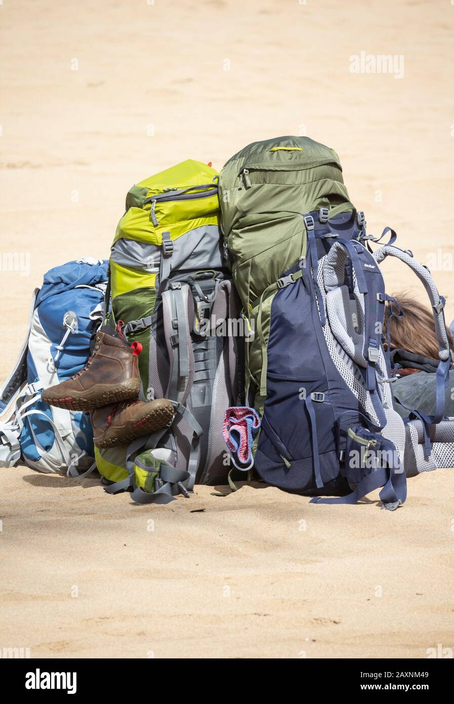 Large Beach Rucksacks Two young people with large rucksacks resting on beach Stock Photo - Alamy