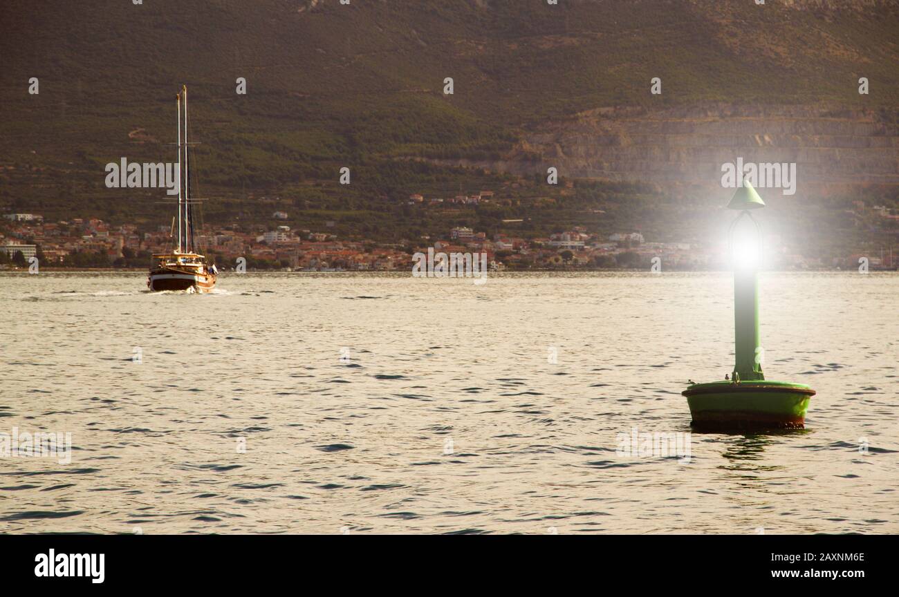 Green light buoy in entrance of sea harbour in Adriatic sea Stock Photo