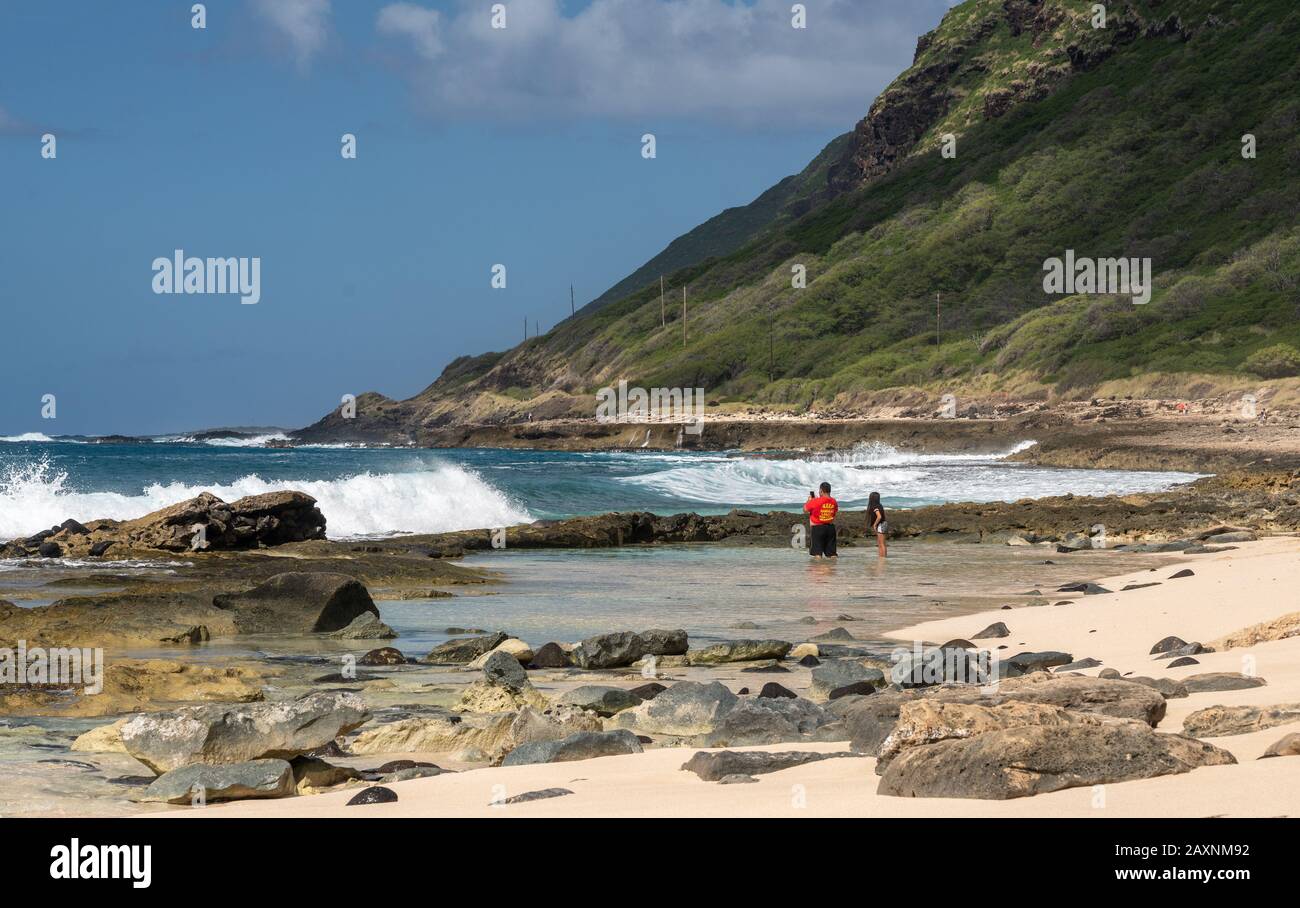 Waianae, HI - 27 January 2020: Locals in rock pool at Ka'ena Point along the west coast of Oahu, Hawaii Stock Photo