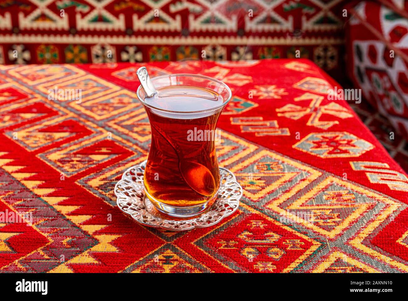 Hot Turkish Tea Cup on a Table with traditional Turkish Tablecloth Stock Photo