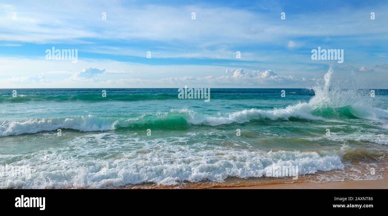 Tropical ocean, sandy beach and blue sky. Wide photo Stock Photo - Alamy