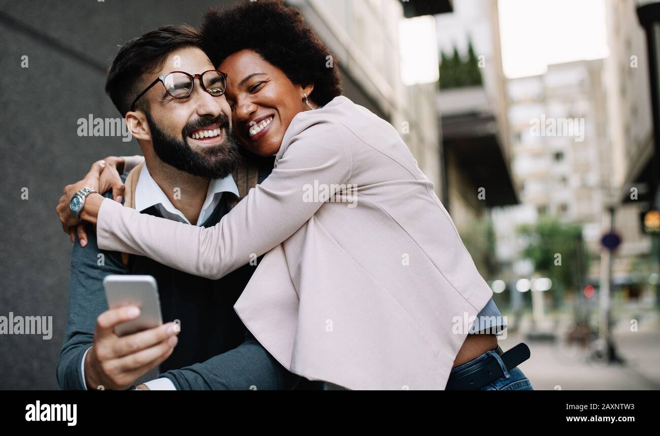 Happy loving couple. Happy young man and woman having fun together in city Stock Photo