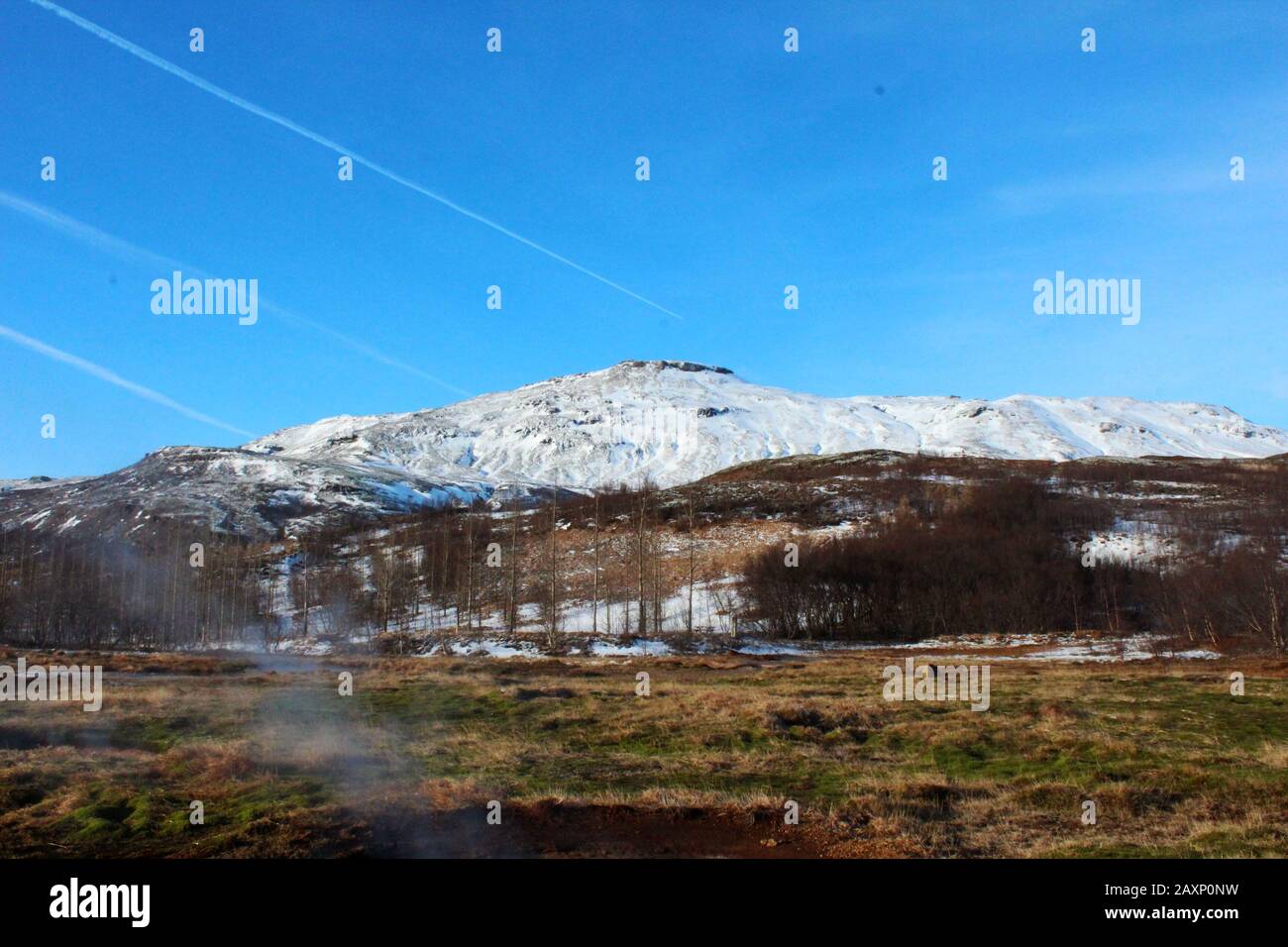 Stunning snowy mountain scenery from Geysir Park, Iceland on a bright day Stock Photo