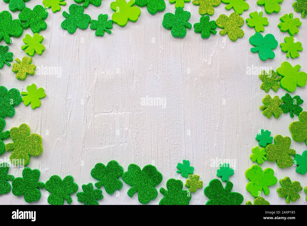Green clovers with a white textured background Stock Photo - Alamy