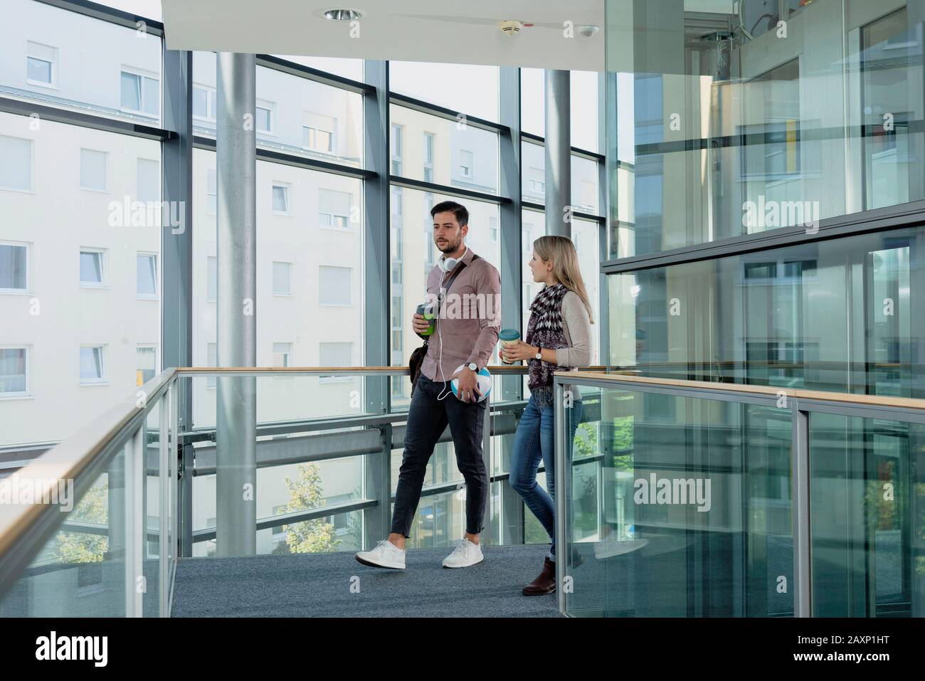 Young woman and young man in modern office building make break Stock Photo