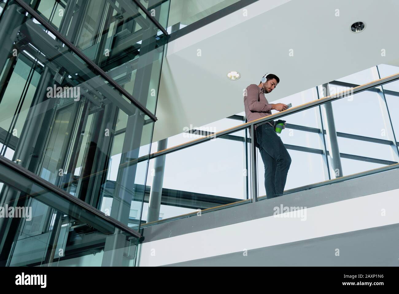 Young man in modern office building has a break Stock Photo