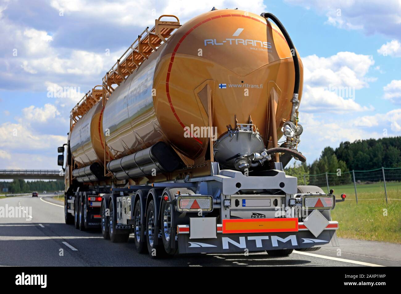 Overtaking a truck pulling double tank trailer on freeway, rear view, on a beautiful day of summer. Akaa, Finland. June 17, 2018. Stock Photo