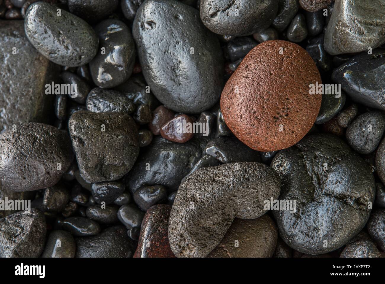 Pebbles on the beach with Tulamben, North Bali Stock Photo