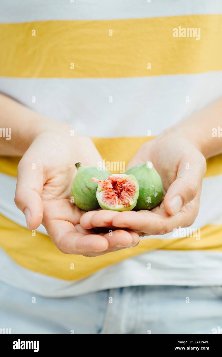 Figs in the hands of a young woman Stock Photo