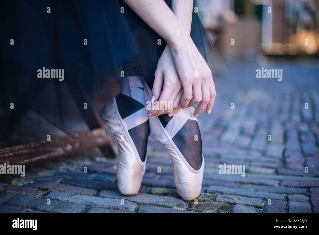 Closeup of ballerina's feet in pointe on street. Strong fit ballerina's