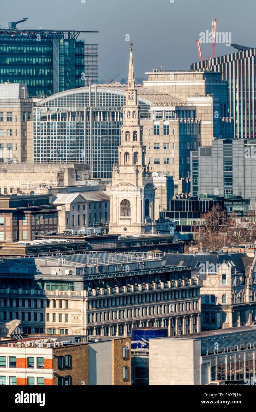 The spire of St Bride's church, Fleet Street, (the inspiration for wedding cake design) seen in the middle of modern London development. Stock Photo