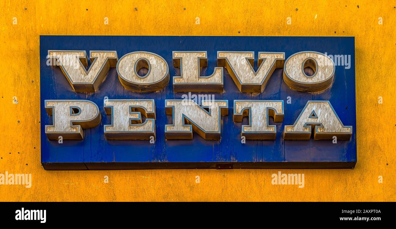 volvo penta, a blue rectangular sign with white letters on a yelloow wall, El Gouna, Egypt, January 16, 2020 Stock Photo