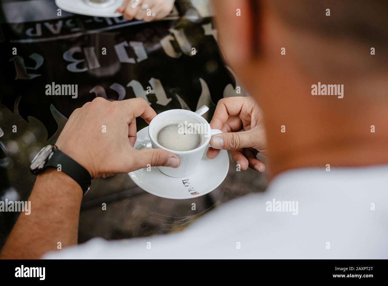 men's hands holding a cup of coffee Stock Photo