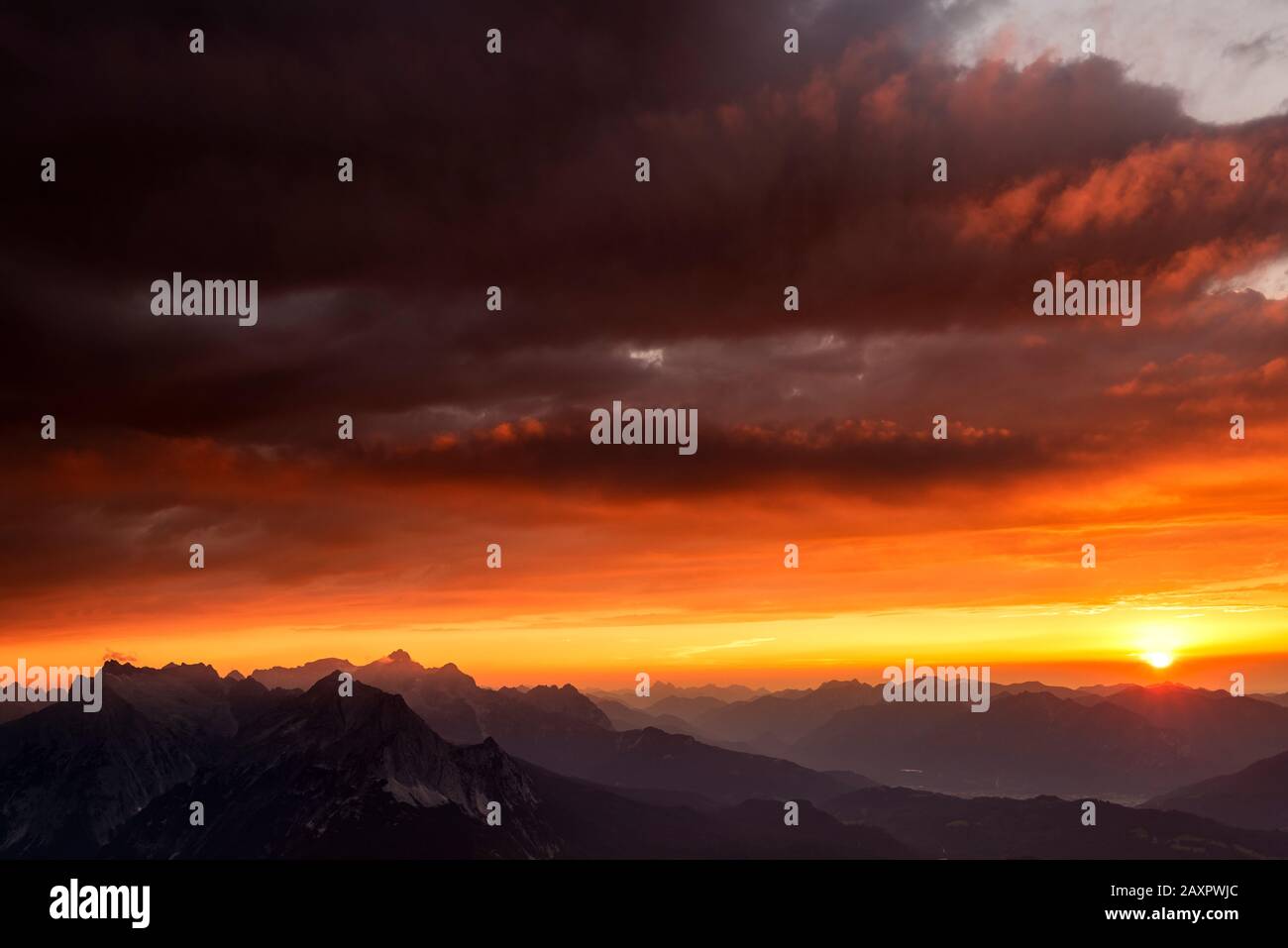 Sunset in the Werdenfelser Land with Zugspitze and Wetterstein mountains, as well as dramatic clouds Stock Photo