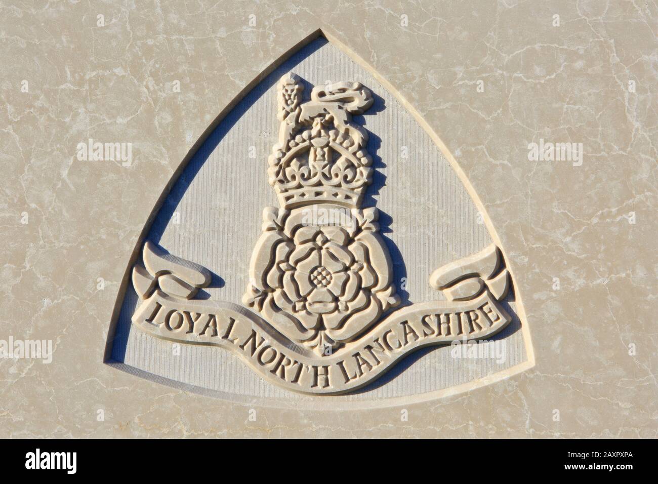 The Loyal North Lancashire Regiment (1881-1970) emblem on a World War I headstone at Tyne Cot Cemetery in Zonnebeke, Belgium Stock Photo