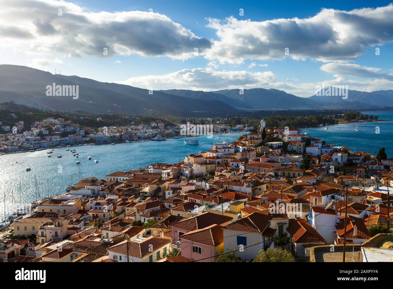 View of the Chora village of Poros island and Galatas village in Peloponnese from a nearby hill, Greece. Stock Photo
