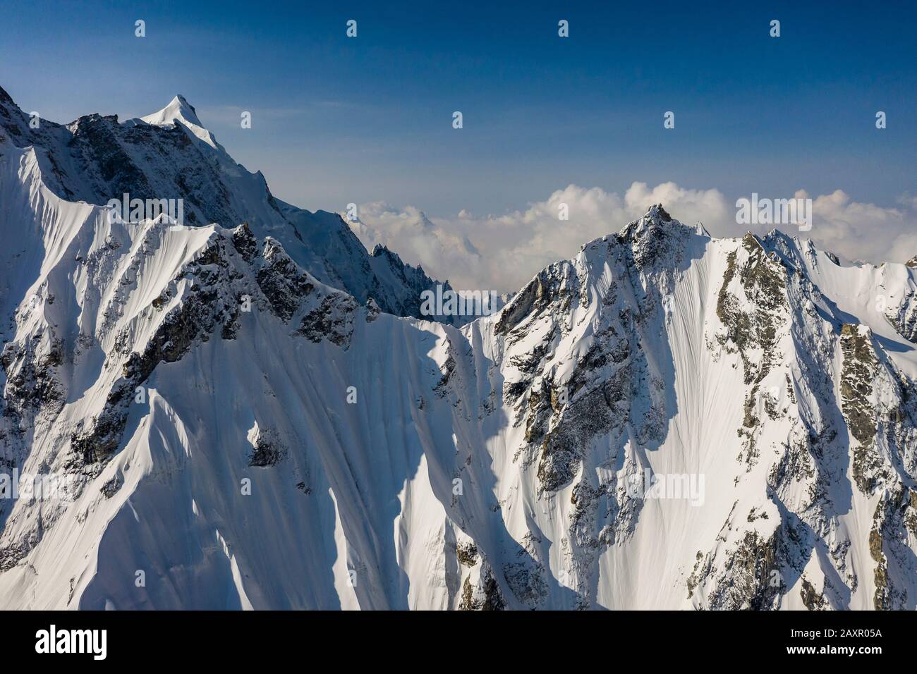 Steep snow covered alpine mountain landscape in the Nepal Himalaya Stock Photo