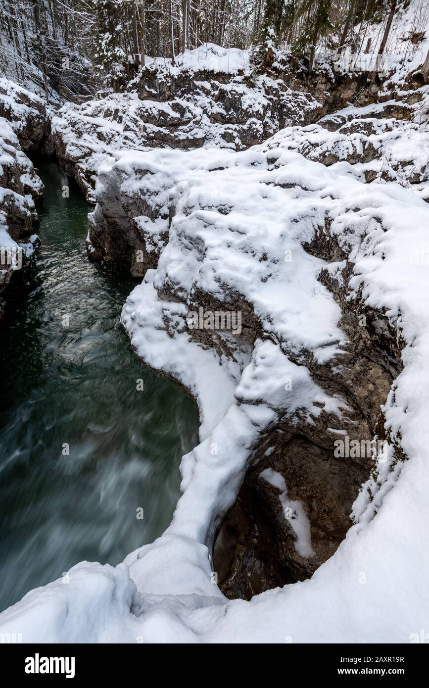 Rock bridge with fresh snow on a gorge in the Karwendel mountains in the Bavarian Alps at Sylvenstein impounding reservoir Stock Photo