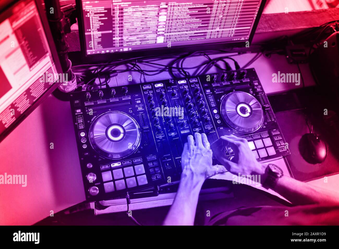 Dj mixes the track in the at a party Stock Photo Alamy