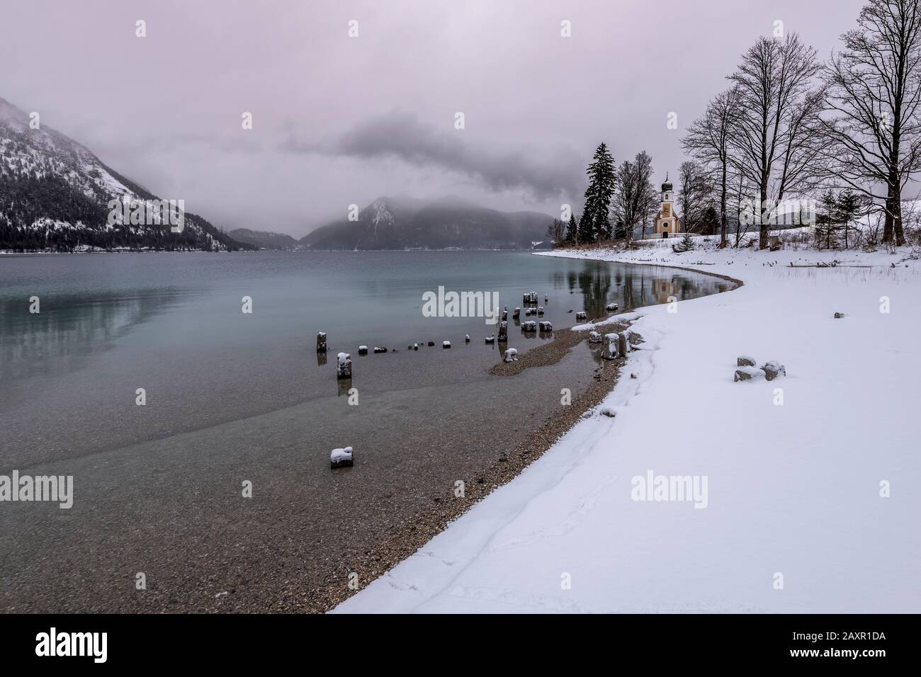 On the Zwergern peninsula on the winter shore of the lake Walchensee in the Bavarian Prealps Stock Photo