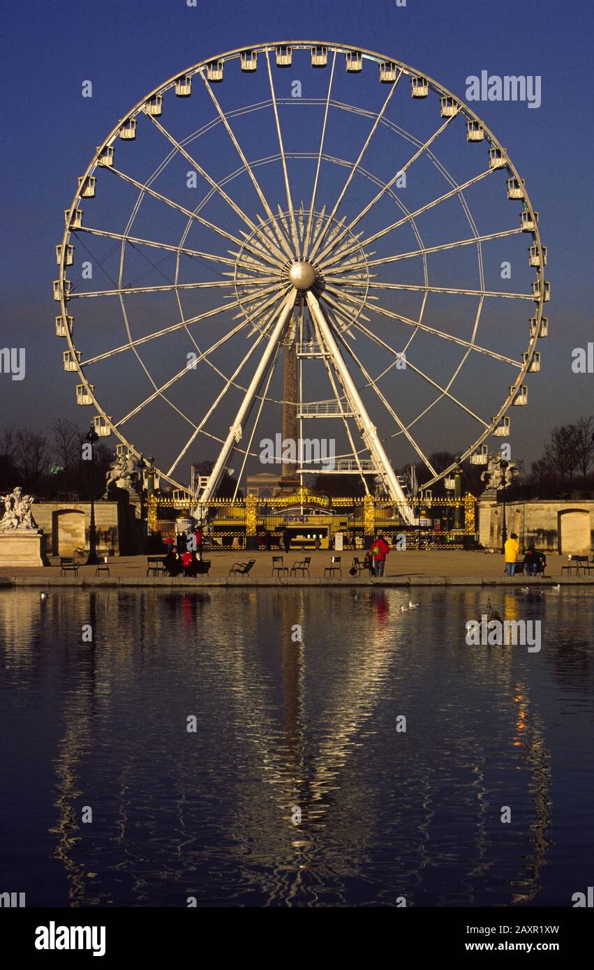 A BIG WHEEL ON PLACE DE LA CONCORDE SEEN FROM THE TUILERIES GARDEN AND
