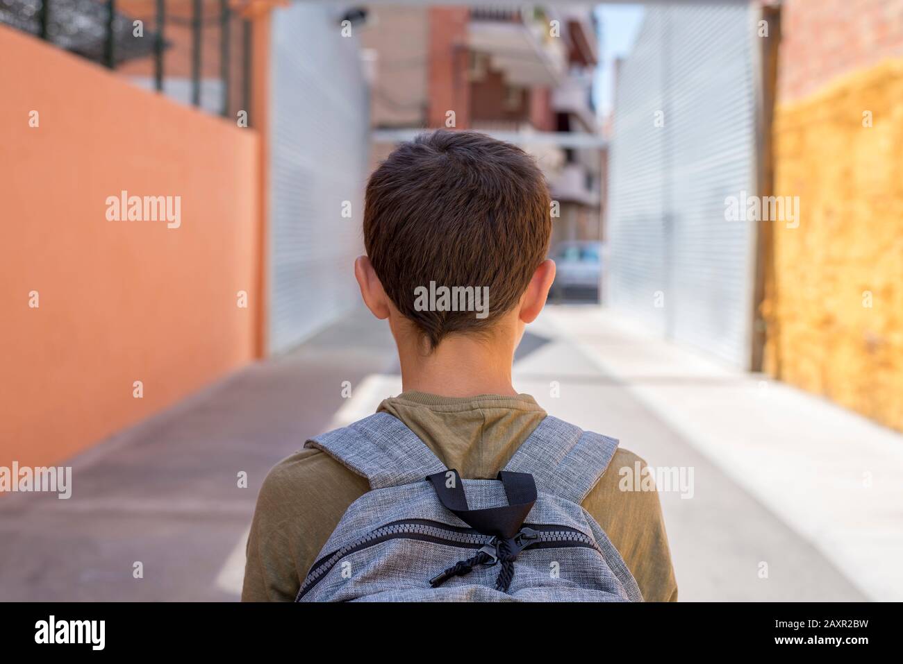 Teenage school boy with a backpack on his back walking to school ( back ...
