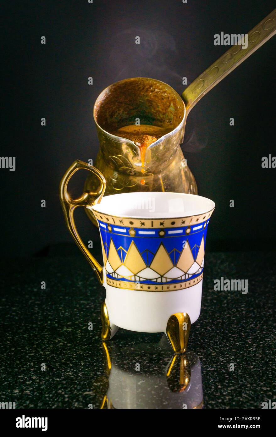 Pouring a cup of traditional Greek cup of coffee. Stock Photo
