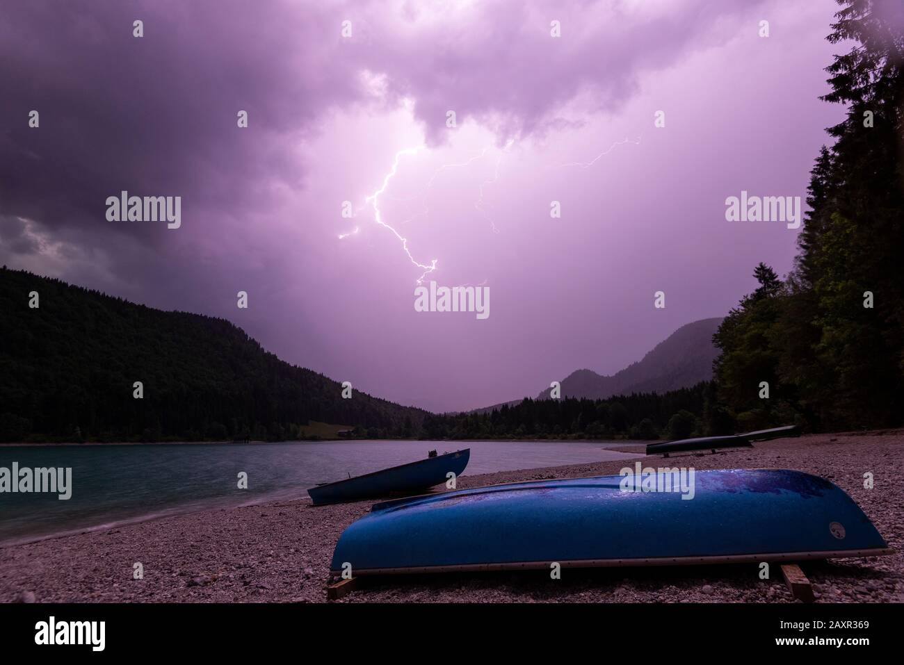 A lightning storm over the boat mooring at lake Walchensee in the bavarian alps. Stock Photo