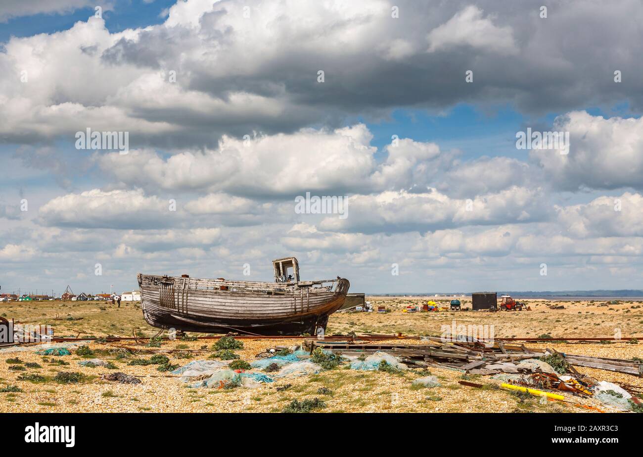 Decaying hull of an old wooden fishing boat abandoned on the shingle ...