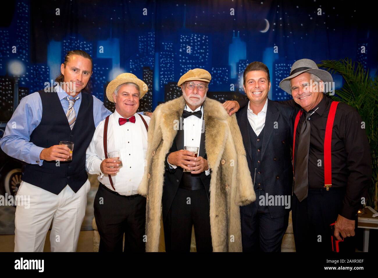 Tough guys pose at a 'Great Gatsby' themed party in Naples, Florida, USA Stock Photo