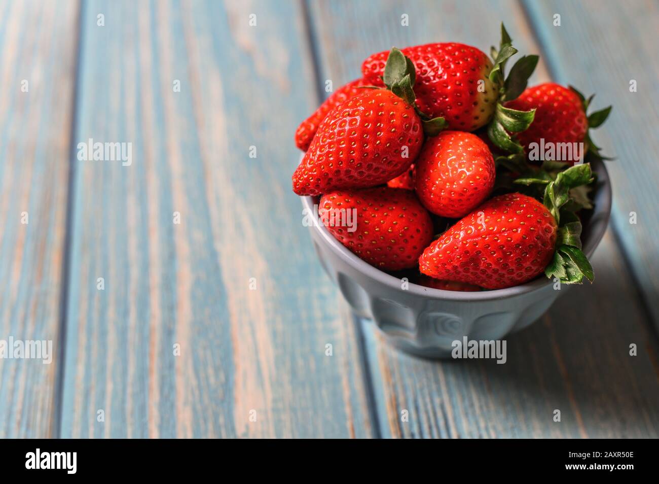 Juicy beautiful organic strawberries on a blue background Stock Photo ...