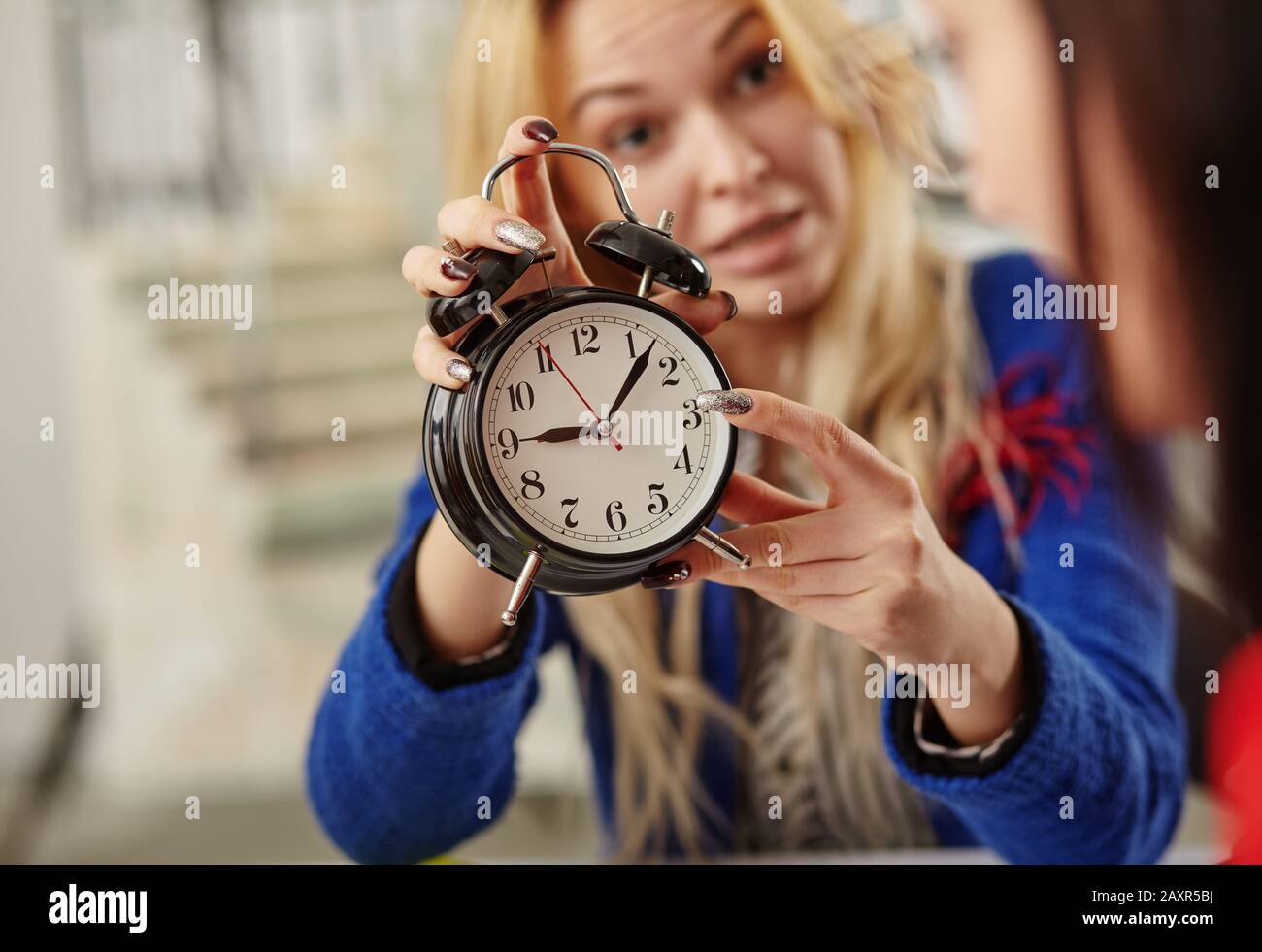 female businessman showing time on the clock. concept about time frame Stock Photo