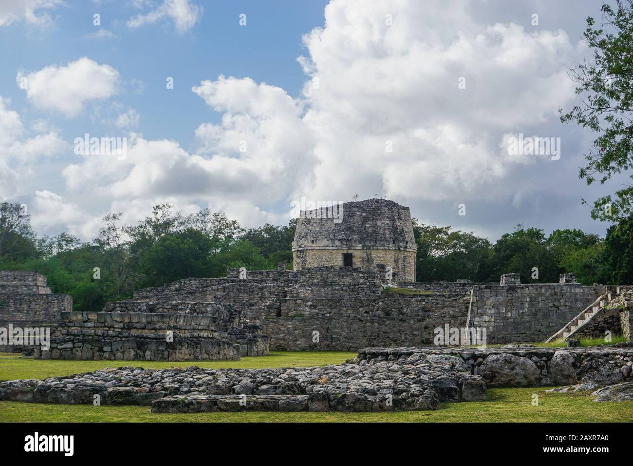 Mayapan, Yucatan, Mexico: El Templo Redondo -- The Round Temple -- with other Mayan ruins in the foreground. Stock Photo