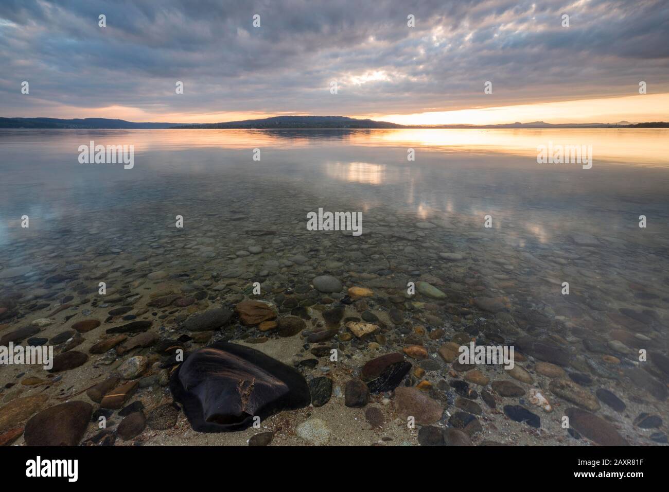 Evening atmosphere on the stony shore in Niederzell, Reichenau, Lake Constance, Baden-Wuerttemberg, Germany Stock Photo