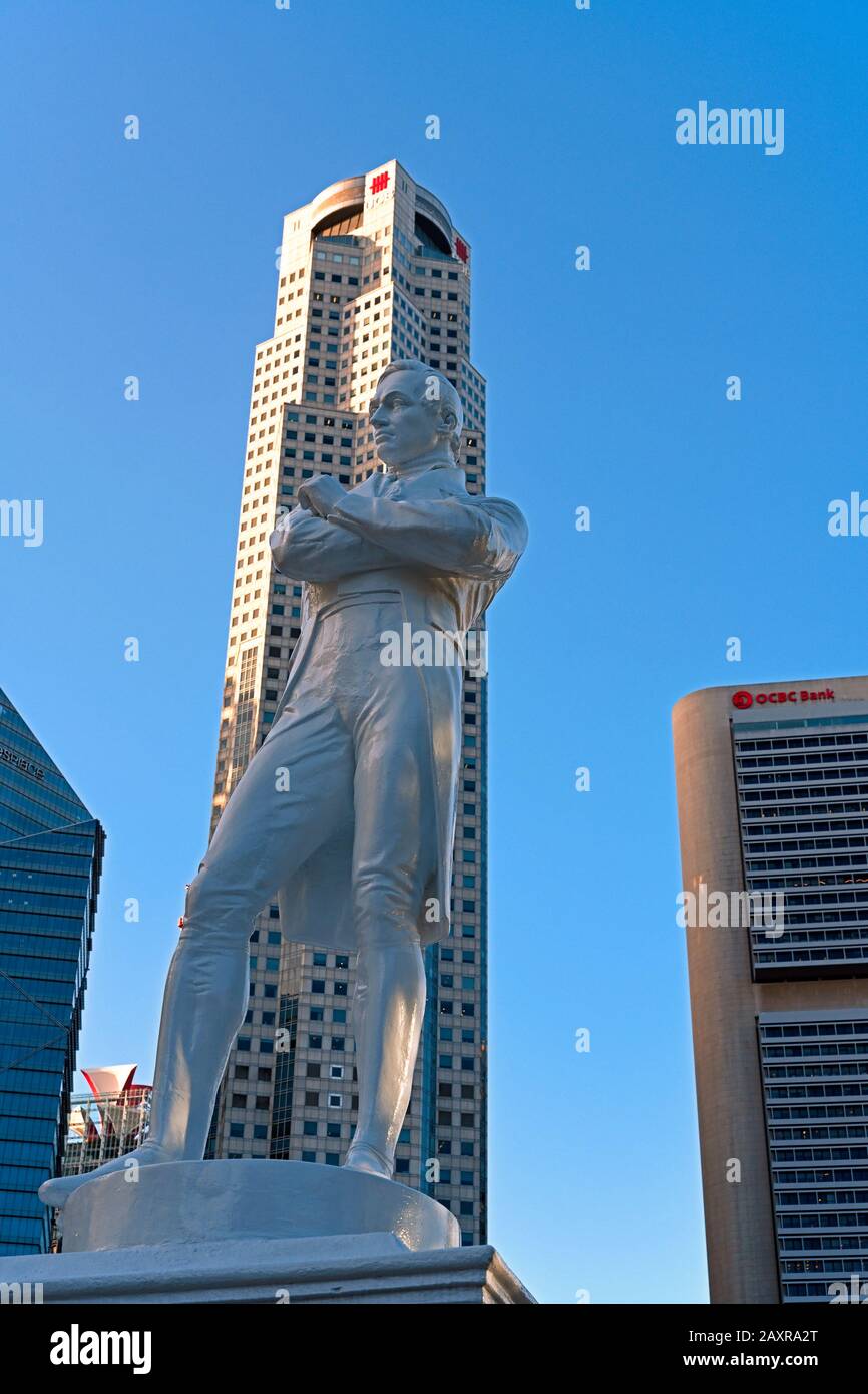 singapore, singapore - 2020.01.24: raffles statue at raffles landing place and high rise office buildings of uob and ocbc in central business district Stock Photo