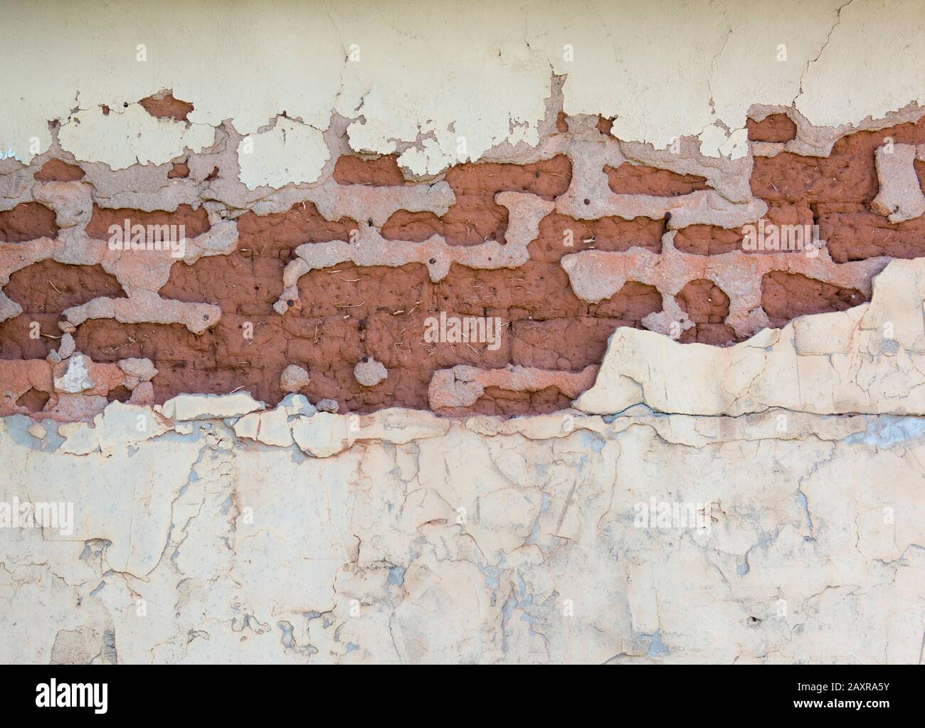 Peeling, chipped paint on an adobe building Stock Photo