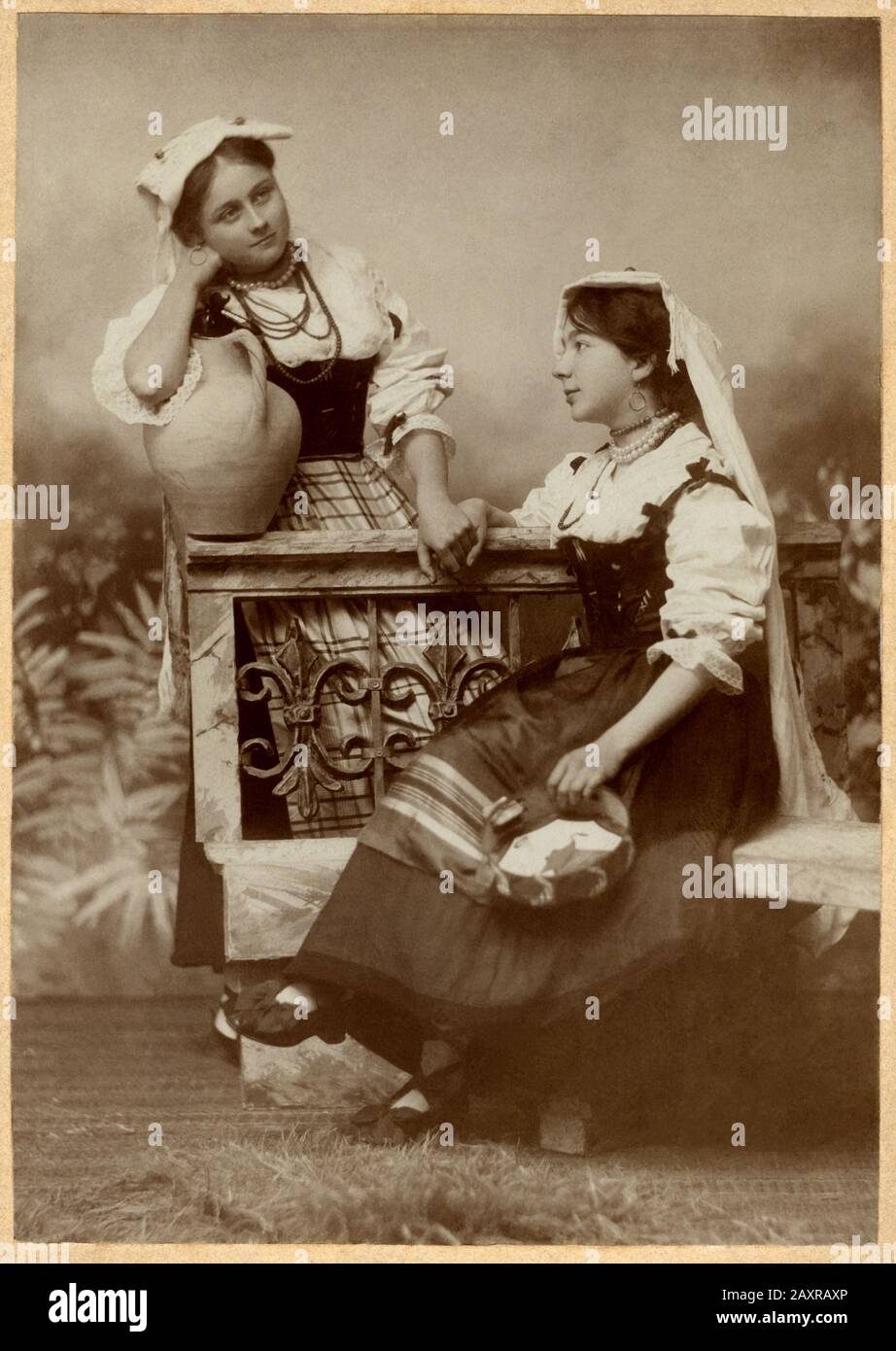 1895 ca, ANCONA ,  ITALY : Portrait of italian women in Folk costume of MARCHE Region . Photo by M. MARINO , Ancona  . The Marino photographer after becoming the official photographer of the Duke of Genova Savoia moved from Ancona ( Piazza Plebiscito, 5 ) to Rome ( Via dei Serpenti, 74 ) in 1918.- PORTRAIT - RITRATTO - HISTORY - FOTO STORICHE - ITALIA  - OTTOCENTO - '800 - 800's -  COSTUME FOLKLORISTICO REGIONALE - FOLKLORE - MODA - FASHION - donna - donne -  shoes - scarpe bianche - hat - cappello - anfora - tamburello - mano nella mano - hand in hand - amiche - friends - amicizia - friendshi Stock Photo