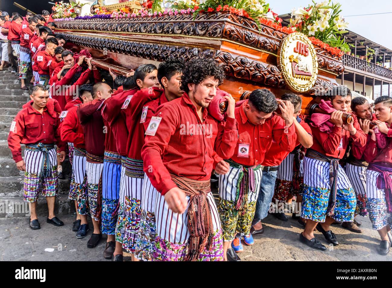 Santiago Atitlan,, Guatemala -  April 19, 2019: Mayan men in traditional costume carry Good Friday procession float in Lake Atitlan town. Stock Photo