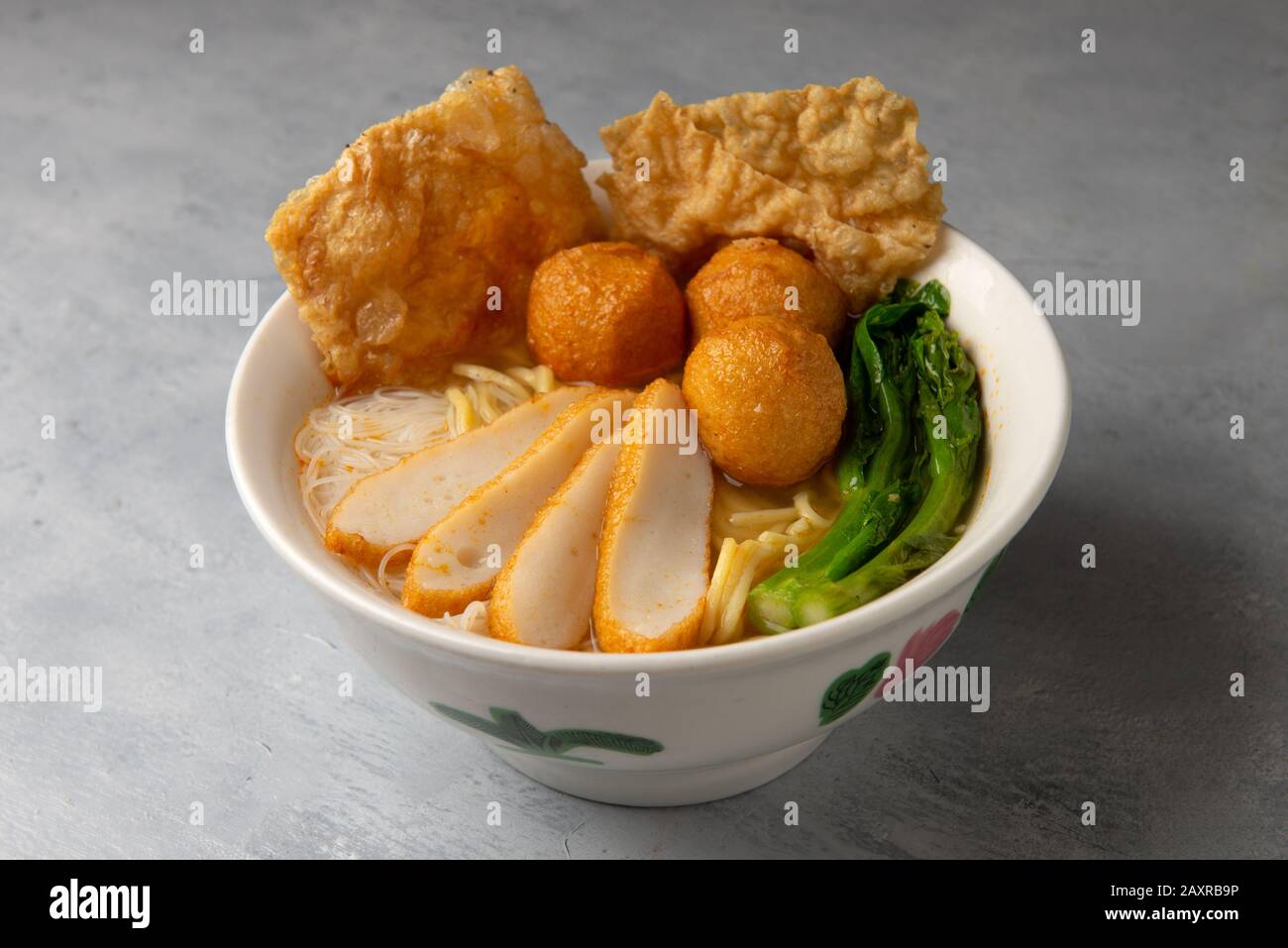 keow teow soup with fishballs and fishcakes chinese style with background Stock Photo