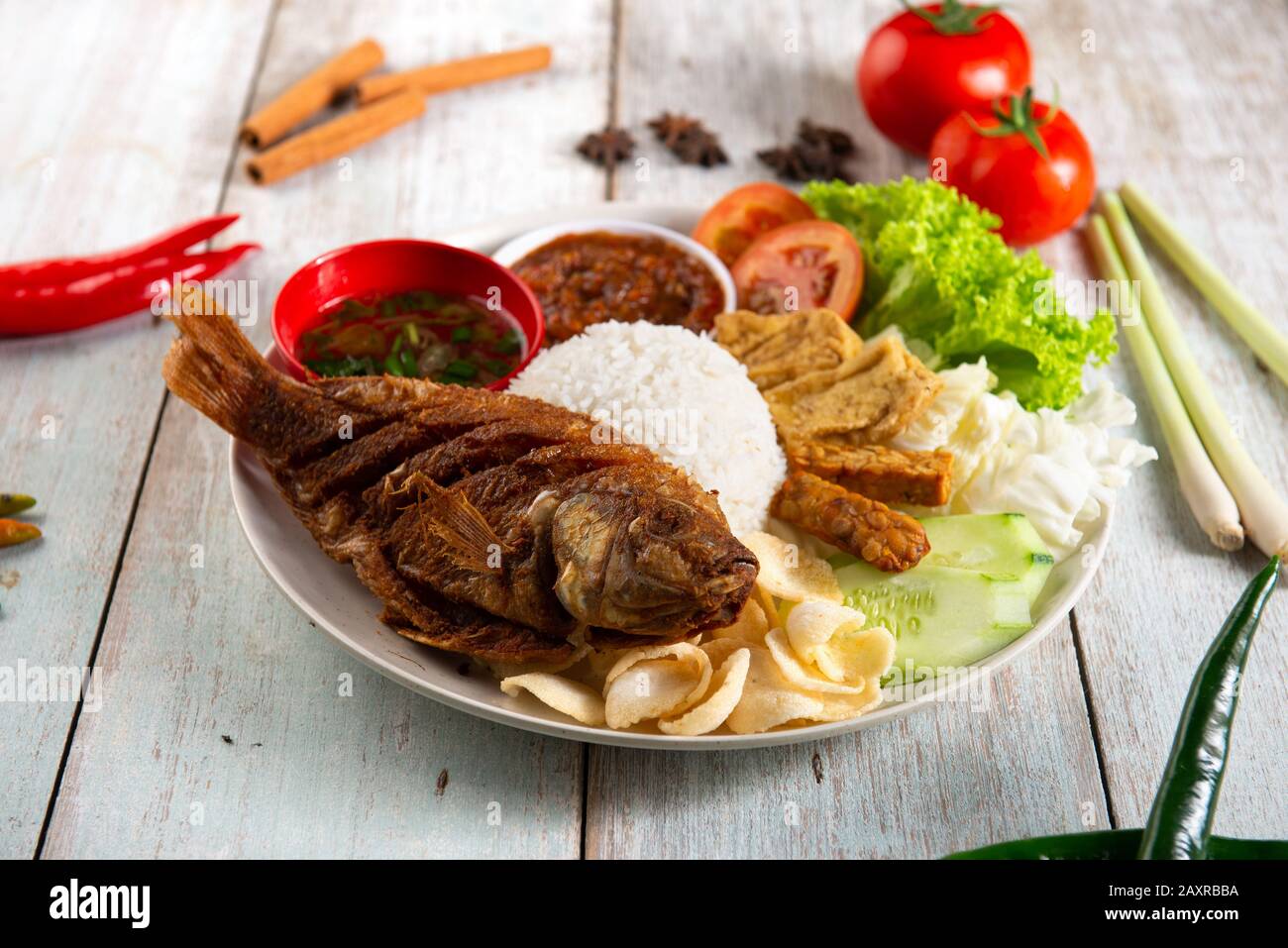 traditional fried fish with rice , sambal , vegables and mixed dish Stock Photo