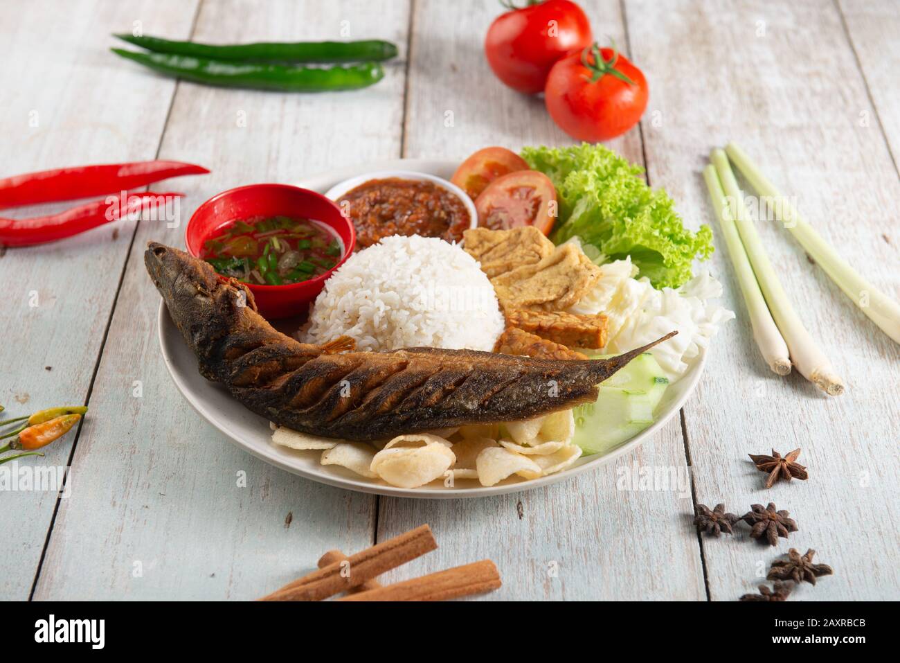 fried catfish with rice , sambal , vegables and mixed dish Stock Photo