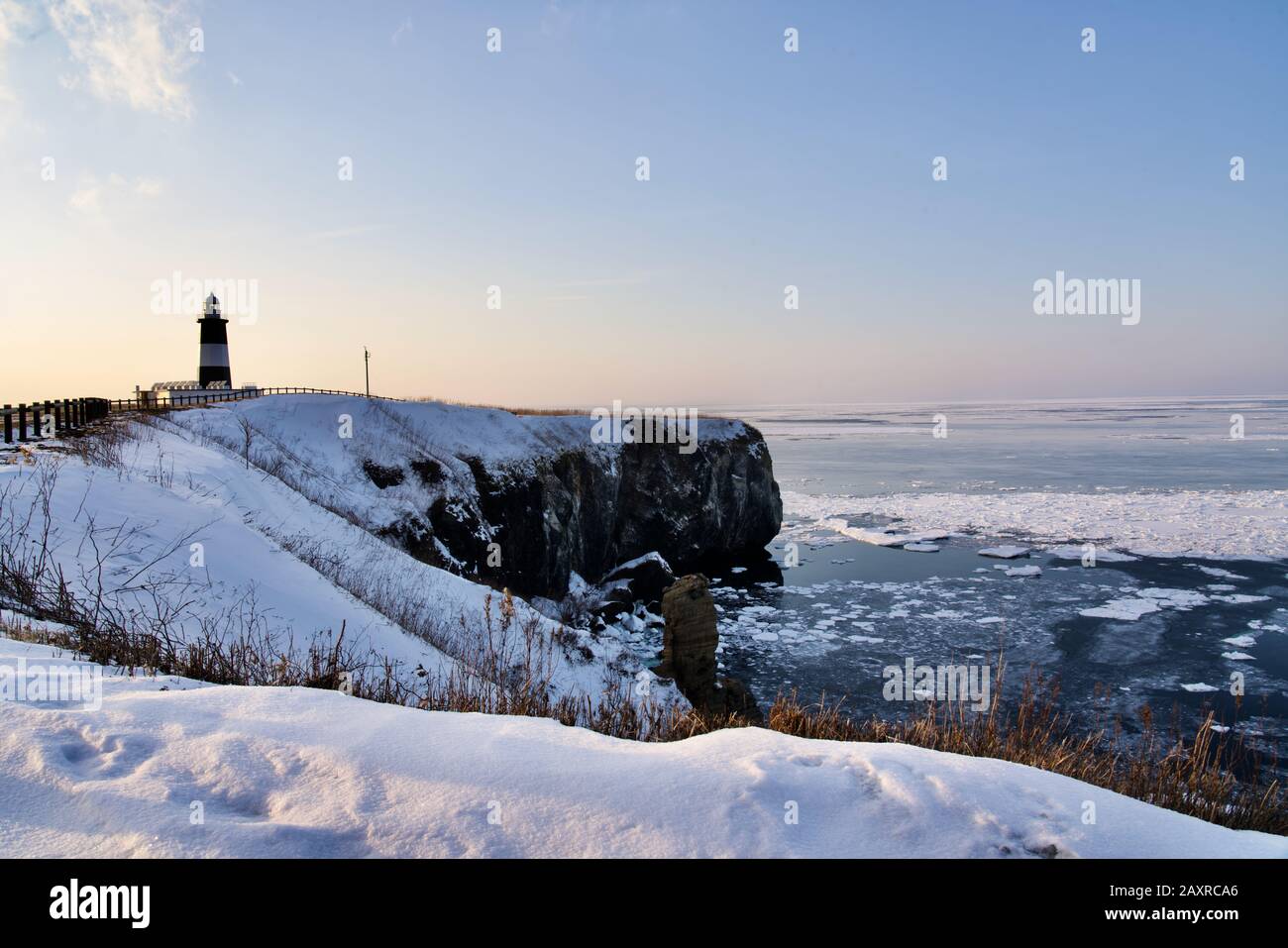 Sunset at Cape Notoro with Notoromisaki Lighthouse in winter, Abashiri, Hokkaido, Japan Stock Photo