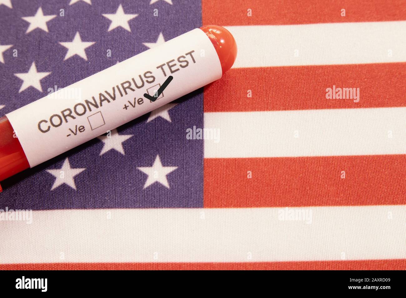 Coronavirus positive test on blood collection tubes on US flag - concept of virus found in USA. Stock Photo