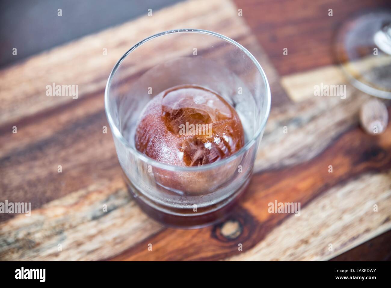 https://c8.alamy.com/comp/2AXRDWY/whiskey-or-scotch-based-cocktail-with-designer-round-ice-cube-2AXRDWY.jpg