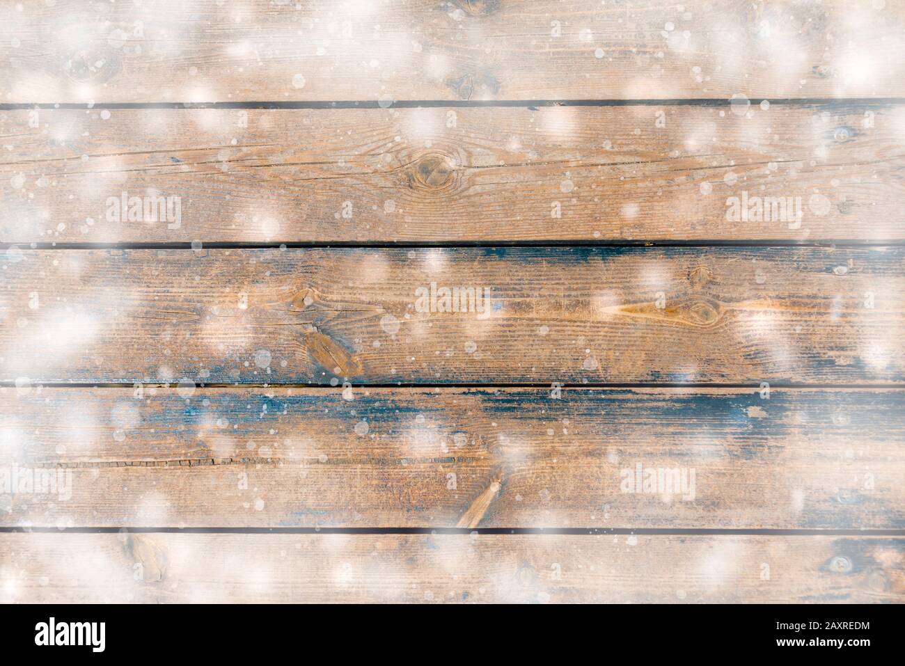 Winter background - top view of dark wooden rustic background covered with snow. Stock Photo