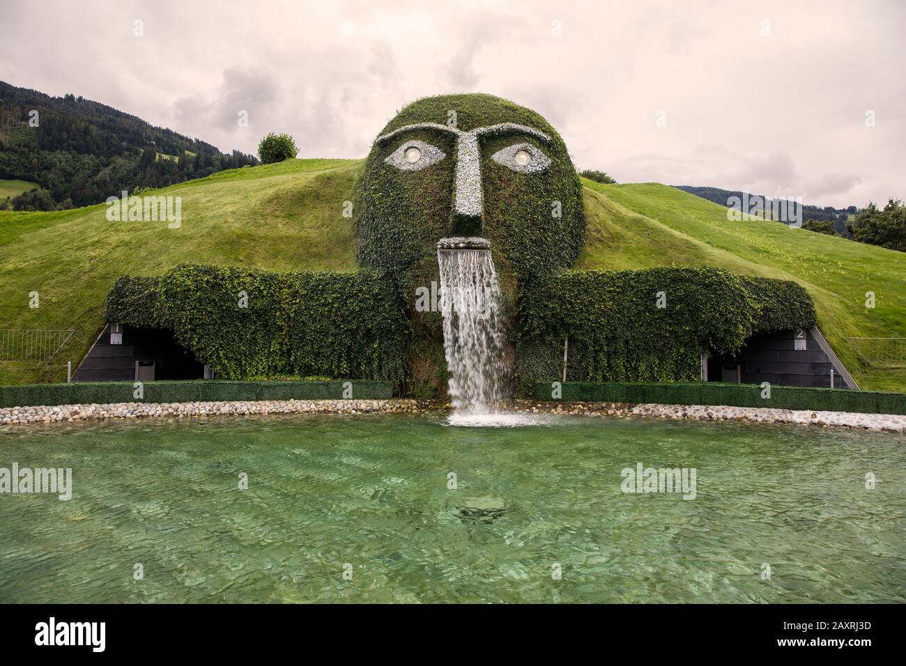 Giant, Andre Heller, Swarovski Crystal Worlds, Innsbruck, spitting water,  mountains Stock Photo - Alamy