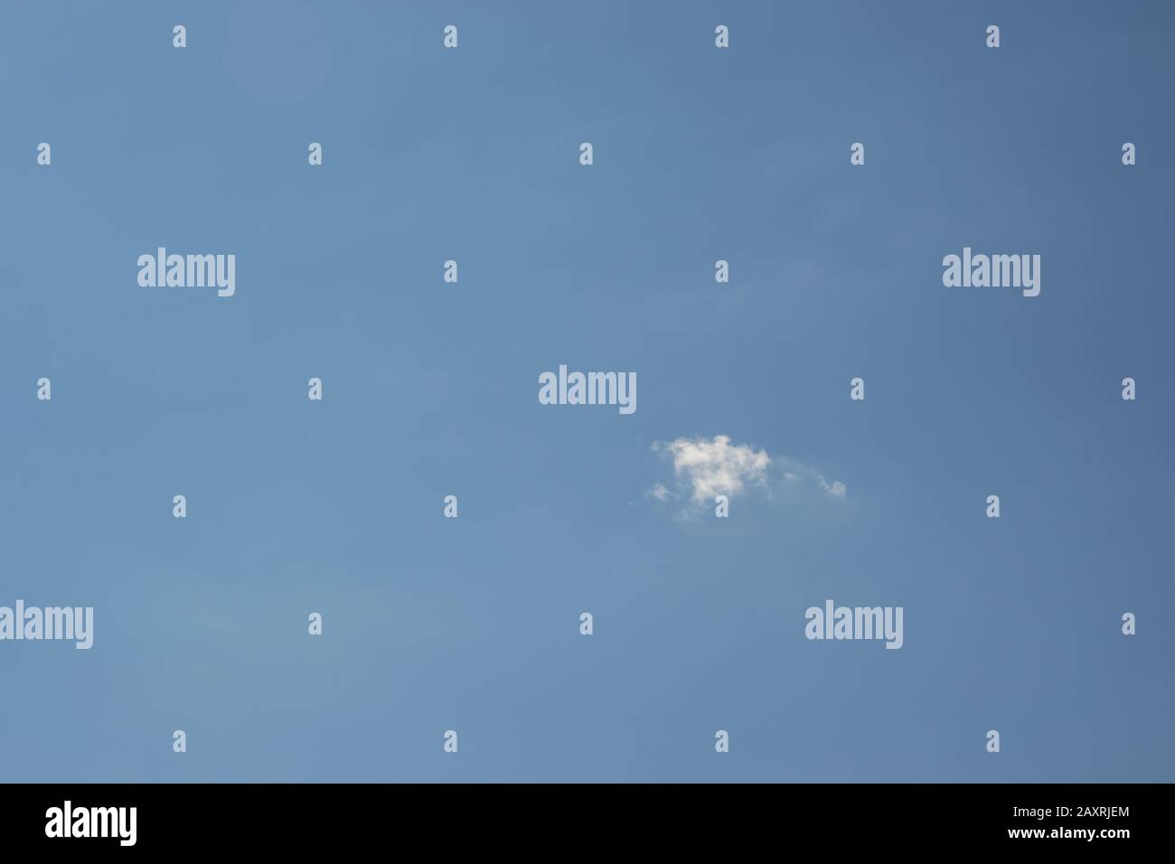 Beautiful blue sky with small white fluffy cloud, copy space, background Stock Photo